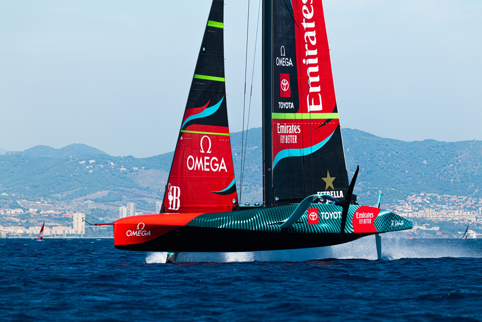 AC75 foiling monohull racing at speed above the water surface