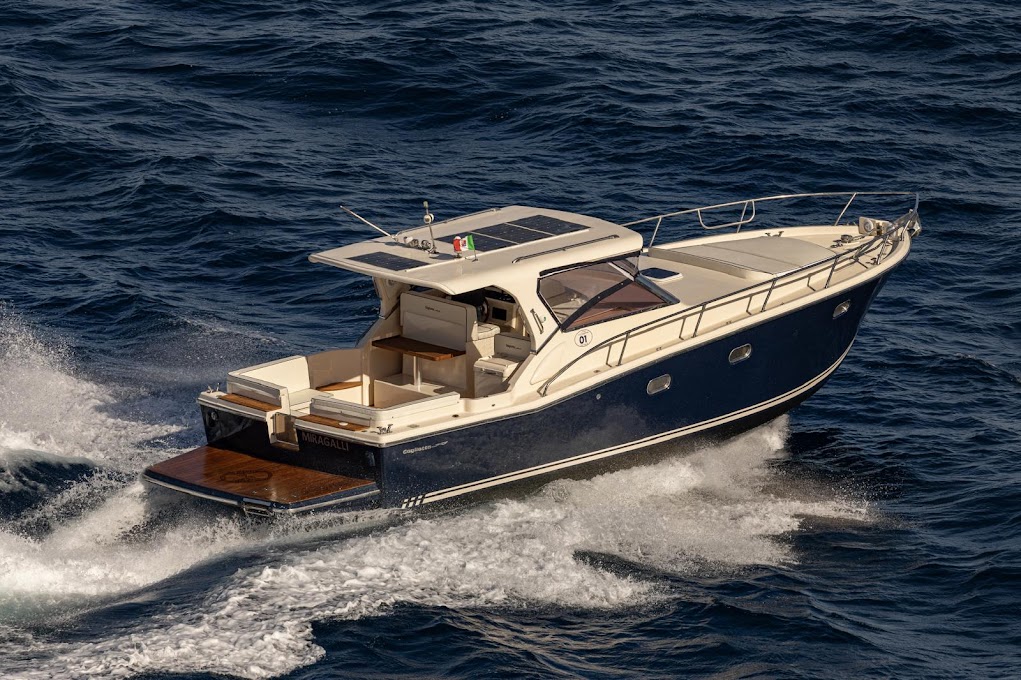 Boat captain in front of the Faraglioni rocks during a private transfer to Capri